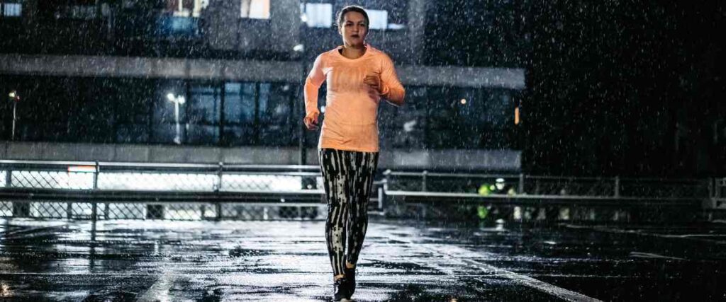 A female runner in the rain. 
